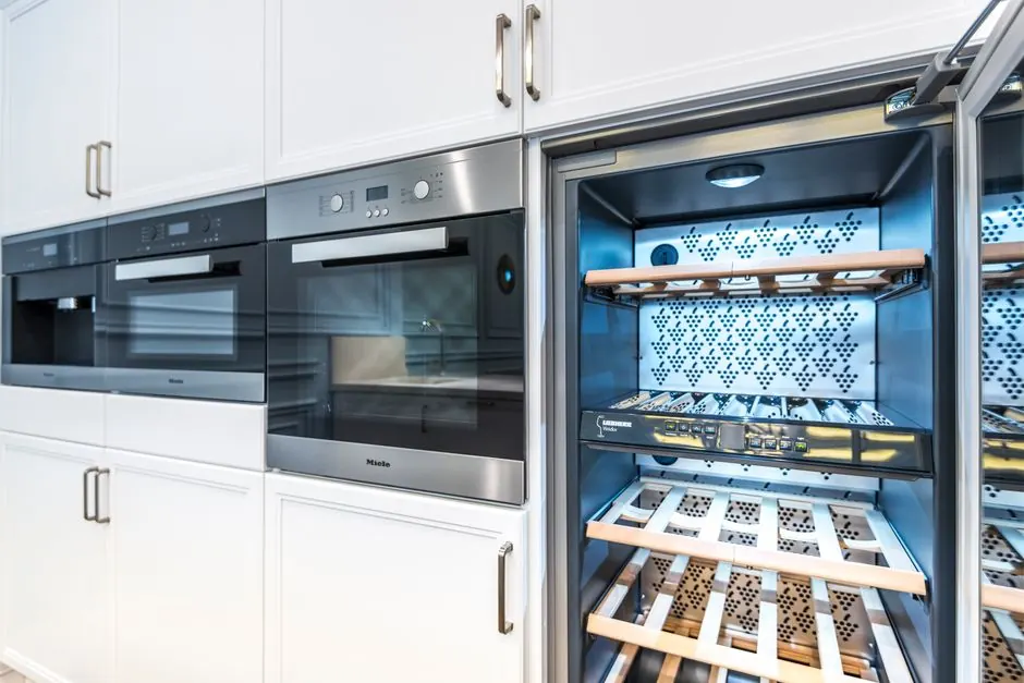 Elegant modern kitchen featuring built-in ovens and a wine cooler.